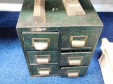 A steel & brass chest of drawers with contents