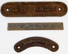 Two cast iron plaques, one an arrow, the other rea