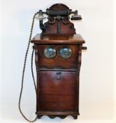 An early wall mounted mahogany telephone 26.5in hi