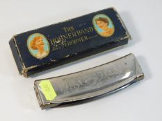 A vintage Hohner harmonica with box