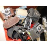 A box of vintage cameras, nine in total