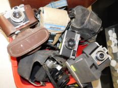 A box of vintage cameras, nine in total