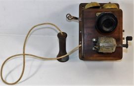 An early wall mounted telephone 9.25in high, heads