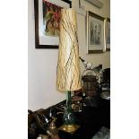 A brass footed tear drop shaped lamp with retro st