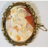 A yellow metal mounted cameo depicting bird of pre