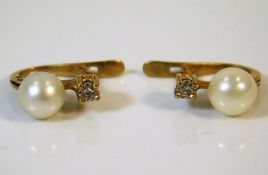 A pair of 9ct gold earrings set with diamonds & cu