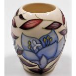 A modern Moorcroft pottery vase with floral decor