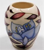 A modern Moorcroft pottery vase with floral decor