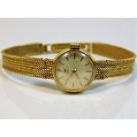 An 18ct gold gold ladies Tissot wristwatch, strap