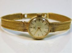 An 18ct gold gold ladies Tissot wristwatch, strap