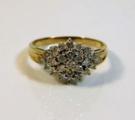 A yellow metal gold cluster ring set with 0.5ct di