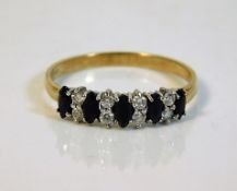 A 9ct gold ring set with sapphire & white stones 1