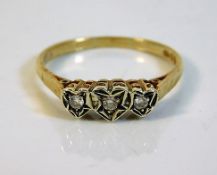 A 9ct gold ring set with three white stones in hea