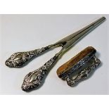A pair of silver handled glove stretchers & a silv