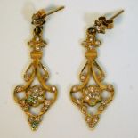 A pair of 18ct gold drop earrings set with diamond