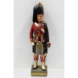 A model of a Scots Guard in uniform 14.25in tall.