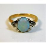 An 18ct gold ring set with opal & diamond 5.8g siz