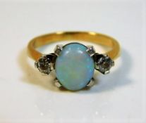 An 18ct gold ring set with opal & diamond 5.8g siz
