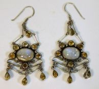 A pair of decorative white metal earrings set with