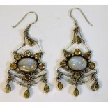 A pair of decorative white metal earrings set with