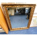 An antique gesso framed gilt mirror 29in x 23in