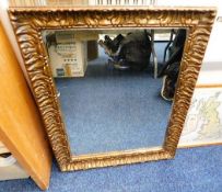 An antique gesso framed gilt mirror 29in x 23in