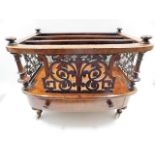 A decorative 19thC. walnut Canterbury with ceramic