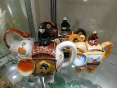 Three Oriental tea pots as elephants