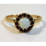 A 9ct gold ring set with opal & garnet 2.1g size M