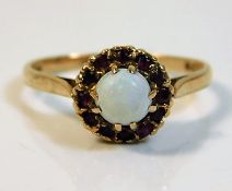 A 9ct gold ring set with opal & garnet 2.1g size M