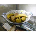 A porcelain basket set with porcelain fruit