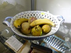 A porcelain basket set with porcelain fruit