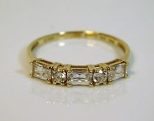 A 14ct gold ring set with white stones 2g size T
