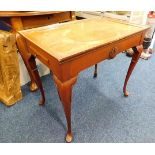 A two drawer tea table with carved shell decor on