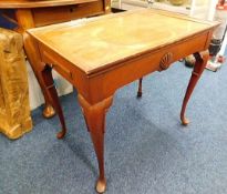 A two drawer tea table with carved shell decor on