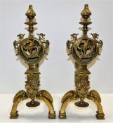 A pair of large brass fire dogs with green man, do
