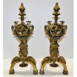 A pair of large brass fire dogs with green man, do