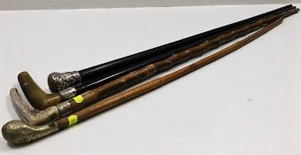 Four vintage walking canes, one with decorative pl