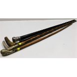 Four vintage walking canes, one with decorative pl