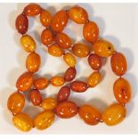 An impressively proportioned antique butterscotch amber beaded necklace 182.7g 34in long, largest be