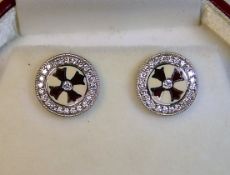 A pair of 18ct white gold earrings with enamelling