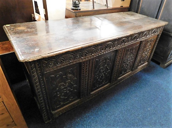 A large 18thC. carved oak coffer 71in wide x 28in