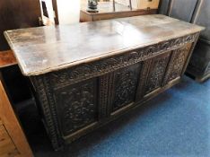 A large 18thC. carved oak coffer 71in wide x 28in