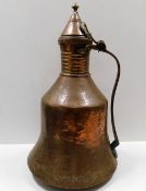 A large 18thC. Persian copper water jug 21in tall