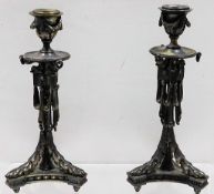 A pair of silvered bronze Regency period candlesti