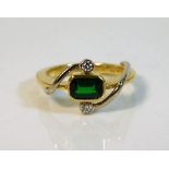 An 18ct gold ring set with green garnet & diamond