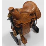 A hand made leather apprentice piece saddle & stan