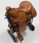 A hand made leather apprentice piece saddle & stan