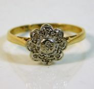 A 18ct gold daisy ring with illusion set diamonds