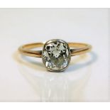 A 19thC. rose gold coloured ring set with a cushion cut diamond of approx. 1.5ct, 1.8g size N, diamo